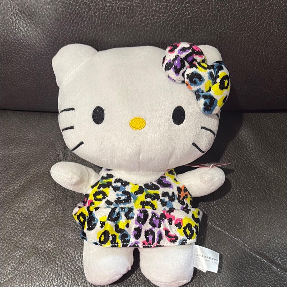 Hello Kitty stuffed animal with rainbow animal dress and bow